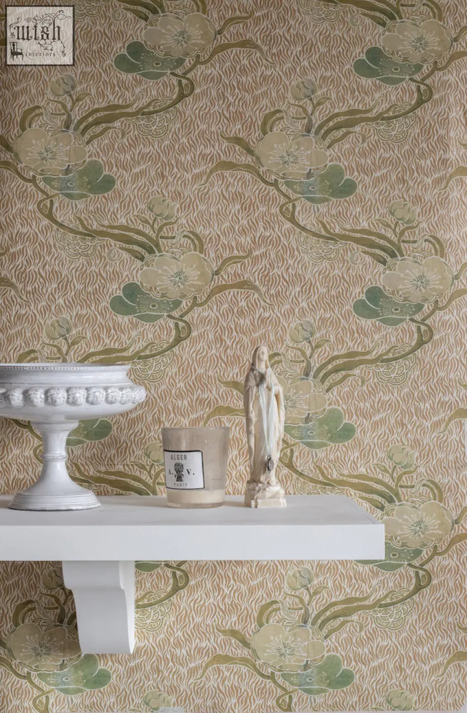 White ceramic pedestal bowl with ornate beaded rim and glossy finish complements nouveau blossom gold wallpaper design