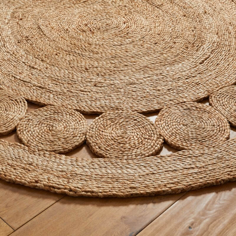 Natural beige nova natural circle rug with handwoven round jute and concentric circles plus decorative edge motifs