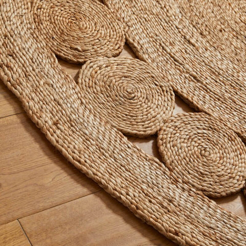 Nova natural circle natural circle rug handwoven round jute rug with woven circular patterns in light beige hue