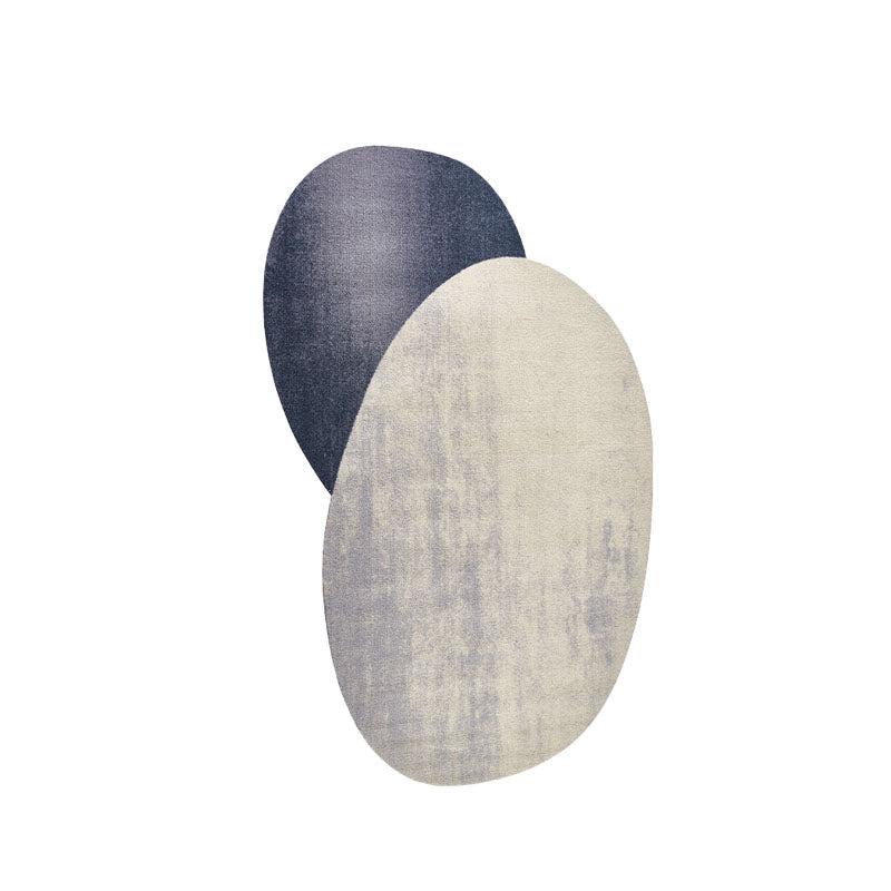 Two overlapping oval wall sconces in deep navy and textured off-white complement nulaa fractal wool decor
