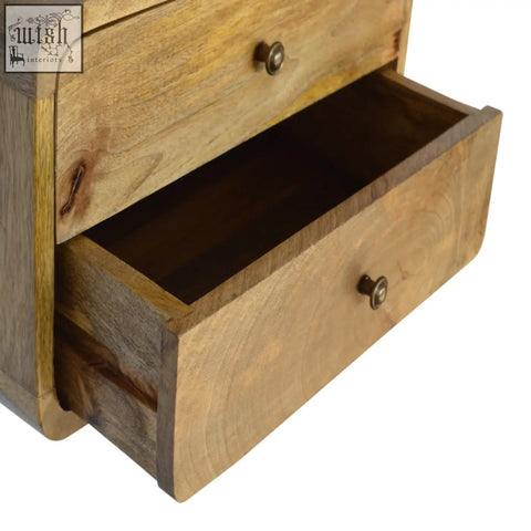 A rustic oak-ish wood two-drawer floating bedside table with brass knobs and natural finish wall-mounted