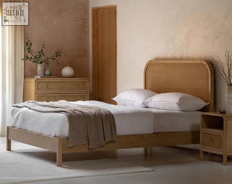 Light oak rattan bed frame with curved headboard and matching oakham bedside cabinet in natural wood finish