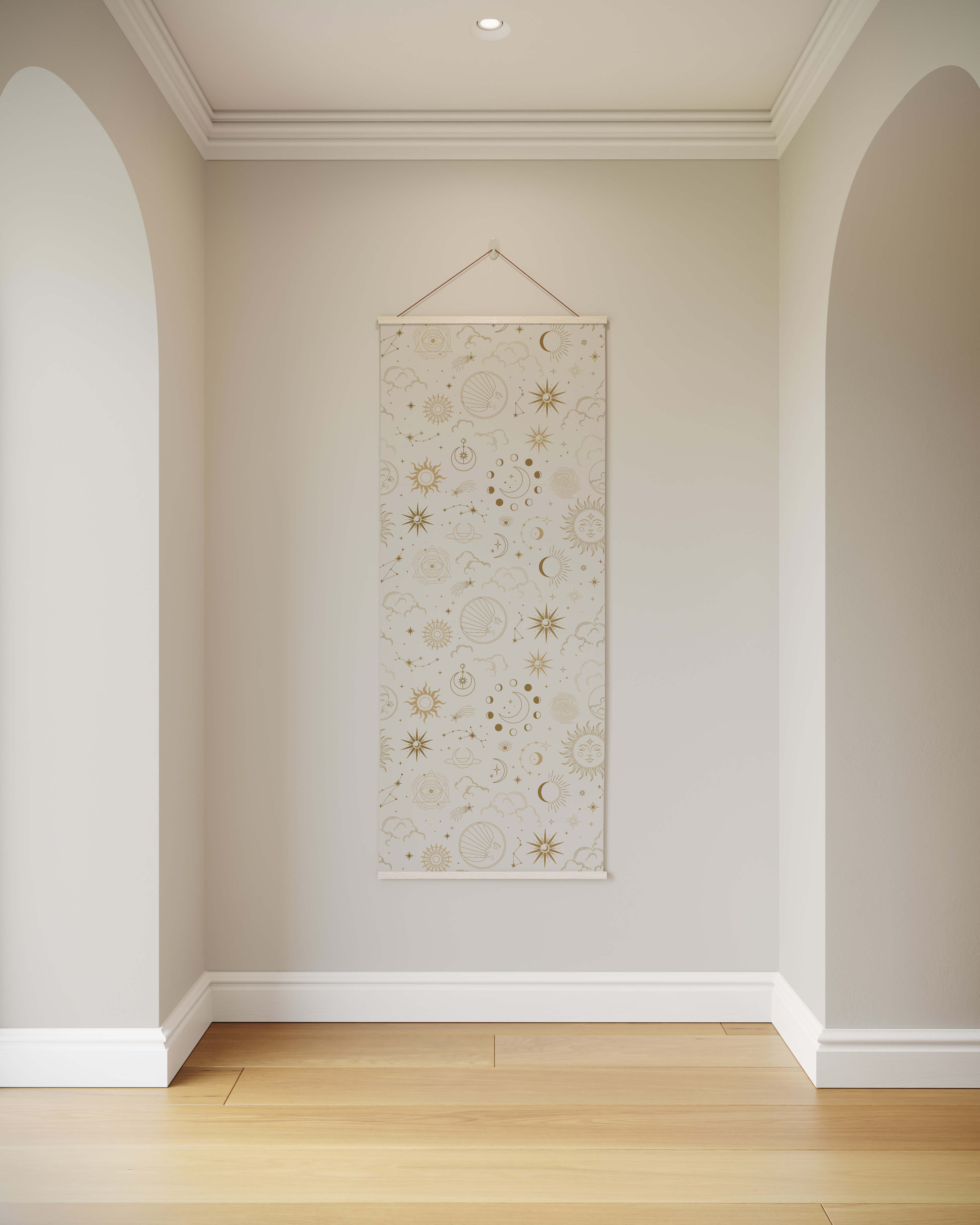 A cream-colored occult pattern tapestry with gold and beige suns moons and stars hanging on a wall