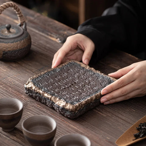 Dark brown ceramic ocha set tea tray with textured uneven edges and a slightly rough surface for serving tea