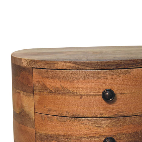Curved odyssey oak-ish tripod bedside table with warm mango wood grain and dark round knobs