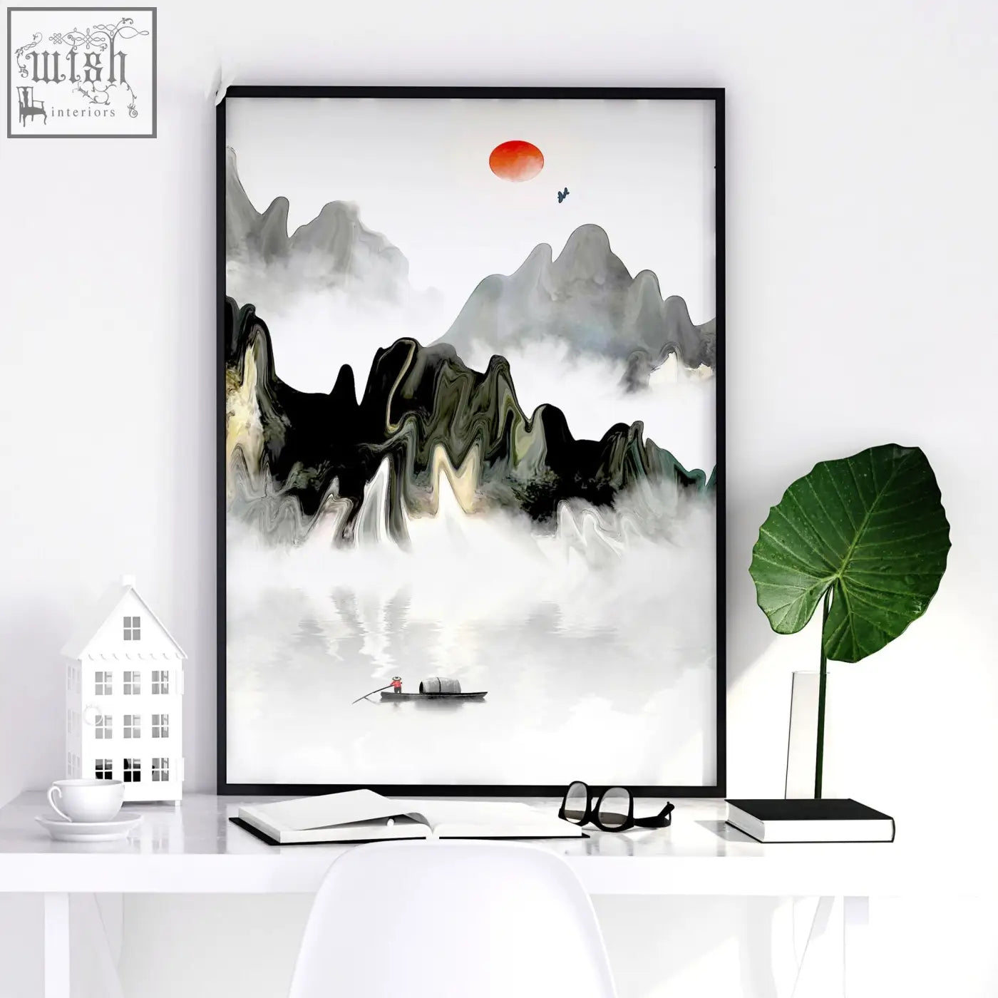 Black-framed minimalist ink wash art prints with misty mountains, small boat, and orange sun for office wall decor