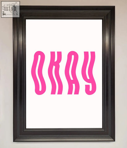 A framed poster showing the word okay in bold wavy pink letters on a white background