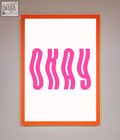 Okay framed poster with bold wavy pink lettering on a white background and a vibrant orange frame