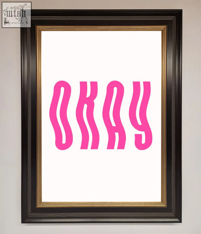 A framed poster with bold wavy pink lettering spelling okay on a white background perfect for casual decor