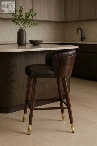 Dark brown leather okazaki bar stool with slender wooden legs and gold-tipped feet for stylish bar seating