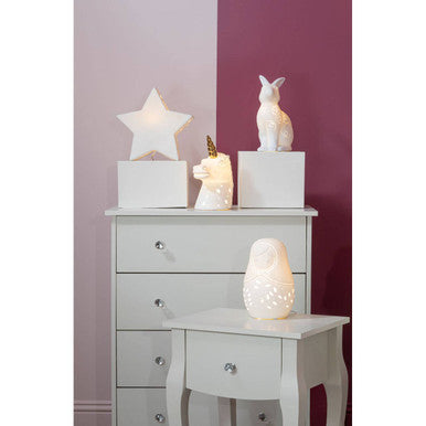 White ceramic owl lamp with perforated design and soft glowing light in ola kids gold horn ceramic night light
