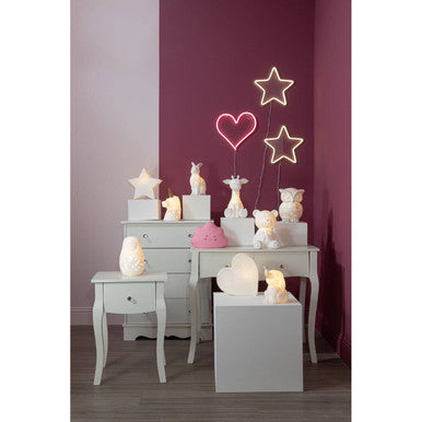 White ceramic ola kids unicorn figurines with soft glowing gold horn ceramic night lights on tiered white shelves