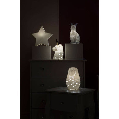 White ceramic night light shaped like a matryoshka doll with delicate cut-outs from ola kids gold horn ceramic collection