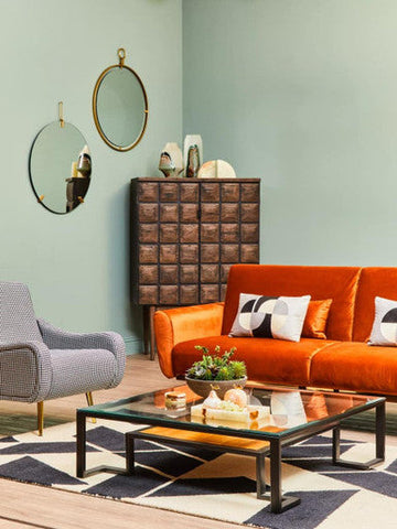 Orange velvet sofa with white and black geometric throw pillows from oleena onyx decorative onyx decorative pear collection