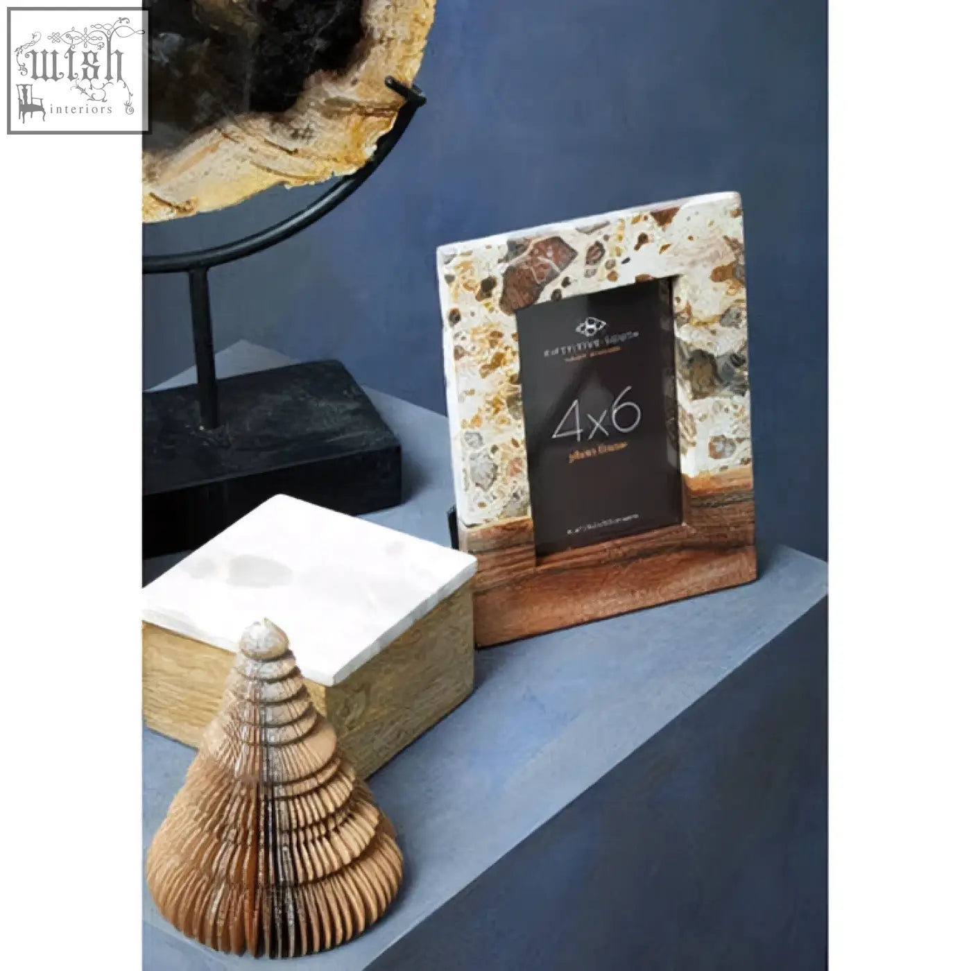 A large photo frame with a textured white and brown stone border and dark wood base perfect for a large photo