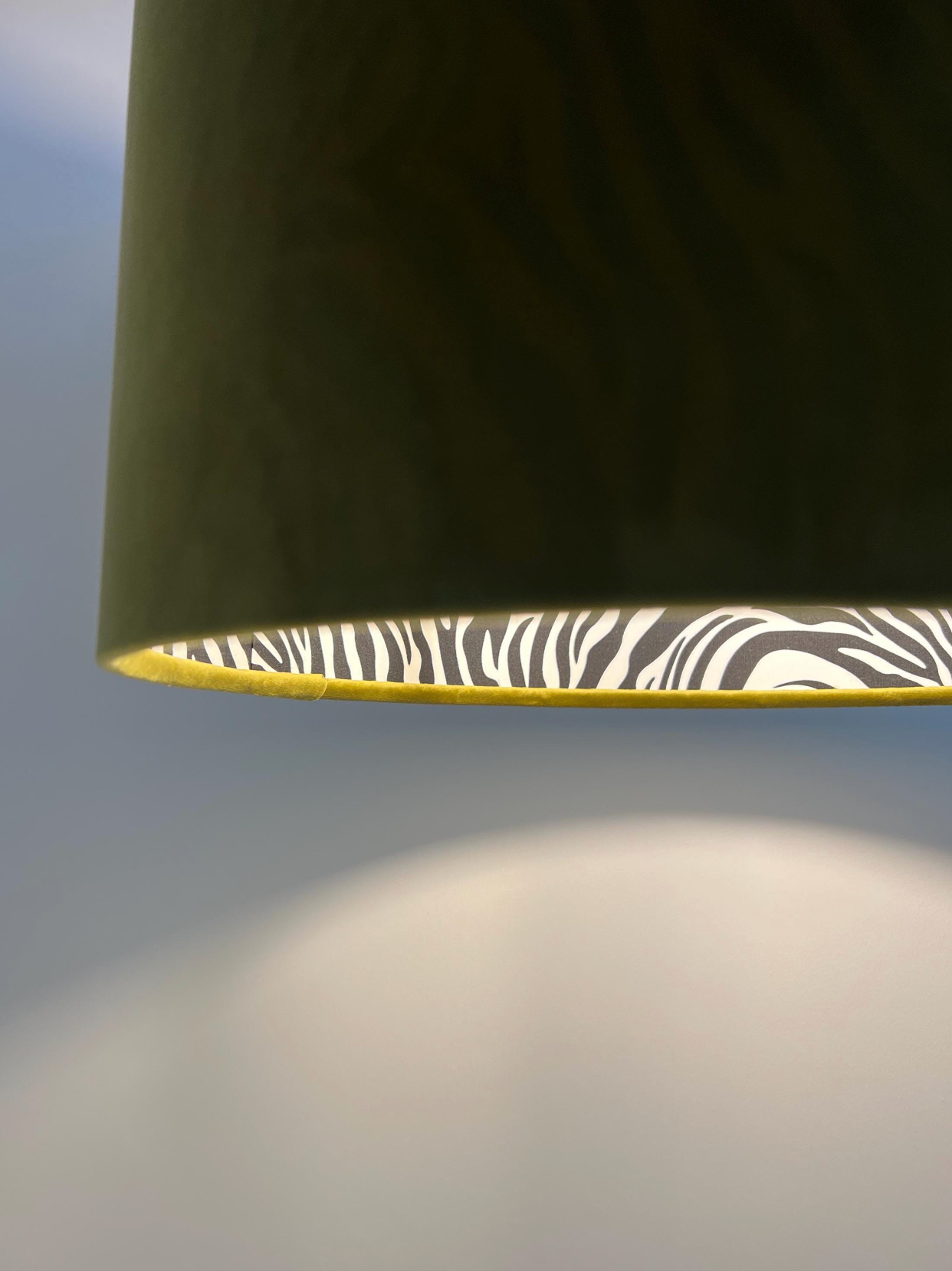 Olive green velvet drum lampshade with zebra-print cotton interior and gold trim handmade ceiling light shade uk