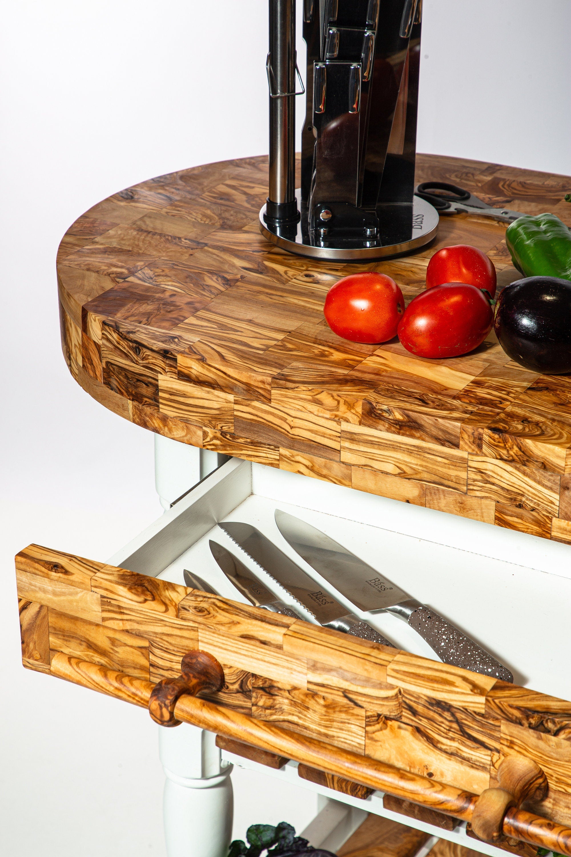 Olive wood butcher block counter island with built-in knife drawer and matching pull handle in natural wood finish