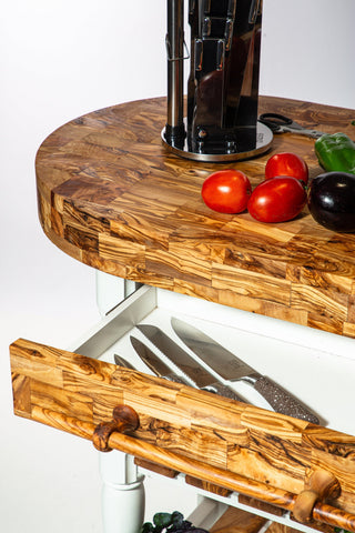 Olive wood butcher block counter island with built-in knife drawer and matching pull handle in natural wood finish