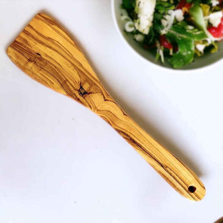 Natural olive wood flat curved spatula 30 cm with smooth polished finish and unique grain patterns for cooking and baking