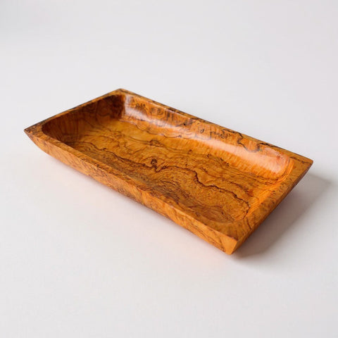 Rectangular olive wood serving tray with warm amber hue and natural swirling wood grain perfect for cheese and appetizers