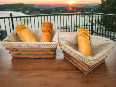 Two rustic olive wood bread baskets with beige burlap liners and lace trim perfect for serving bread