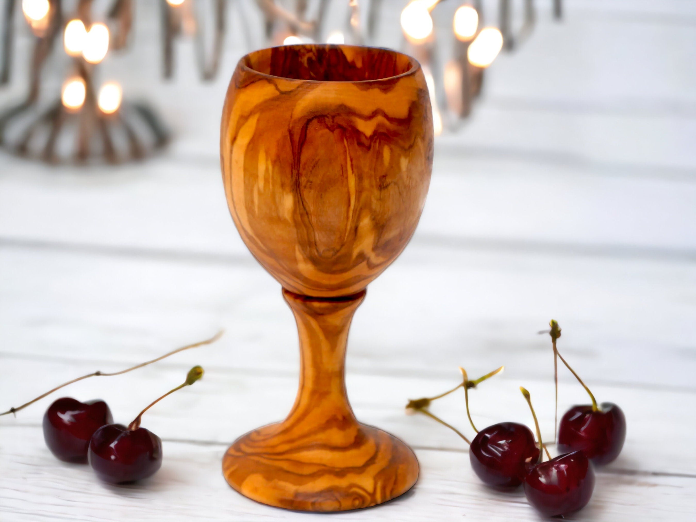 Handcrafted amber olive wood goblet with swirling marbled pattern and sturdy stem for bottles holder or bar accessories