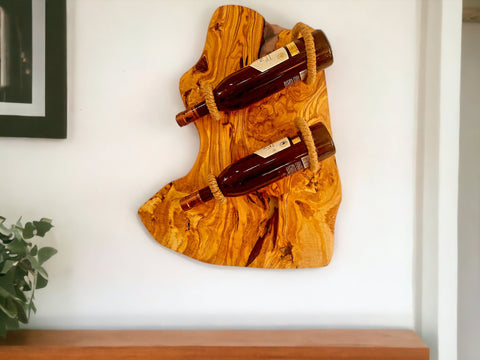 Rustic golden-brown olive wood bottle holder with natural grain and thick rope securing three wine bottles perfect as a gift