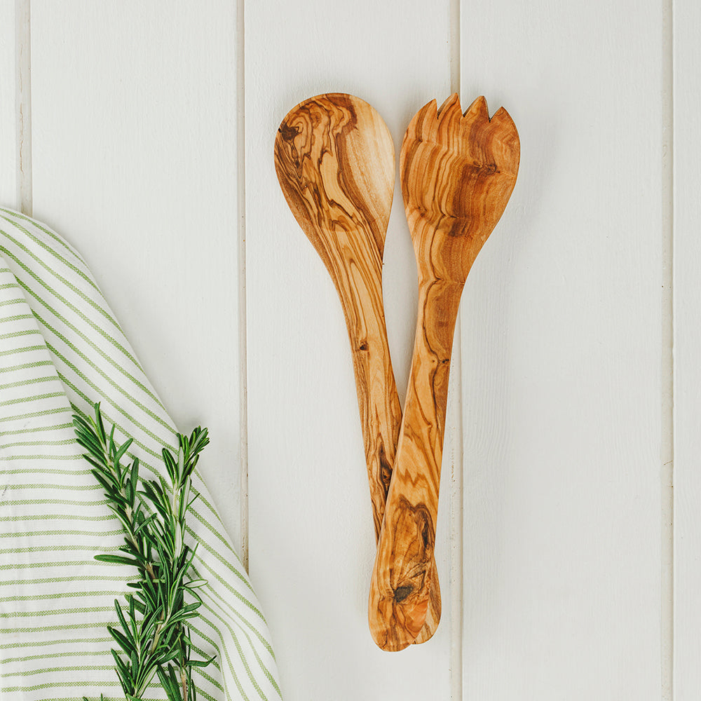 A pair of olive wood salad servers with warm brown finish and swirling grain perfect for wood salad serving