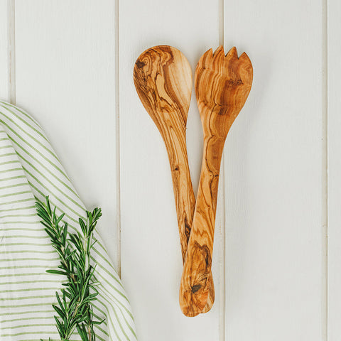 A pair of olive wood salad servers with warm brown finish and swirling grain perfect for wood salad serving