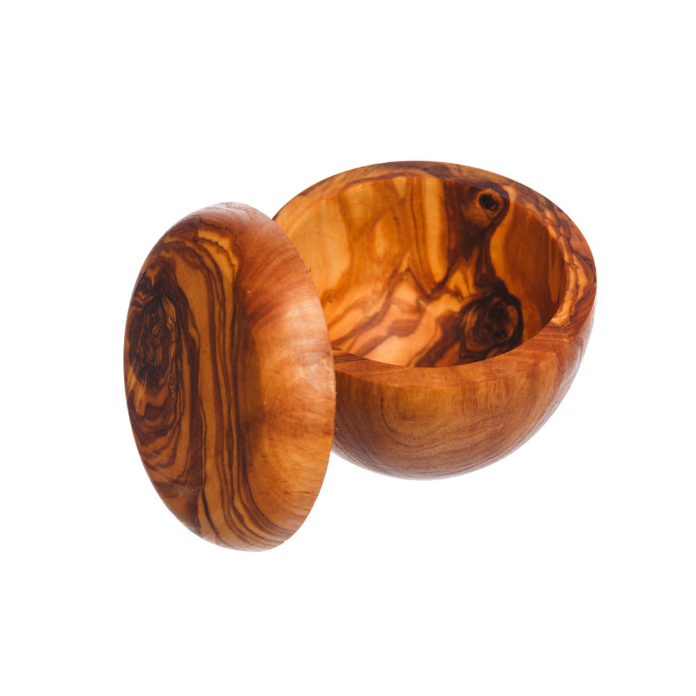 Handcrafted olive wood salt pot with matching lid showing warm amber and dark brown swirling grain patterns