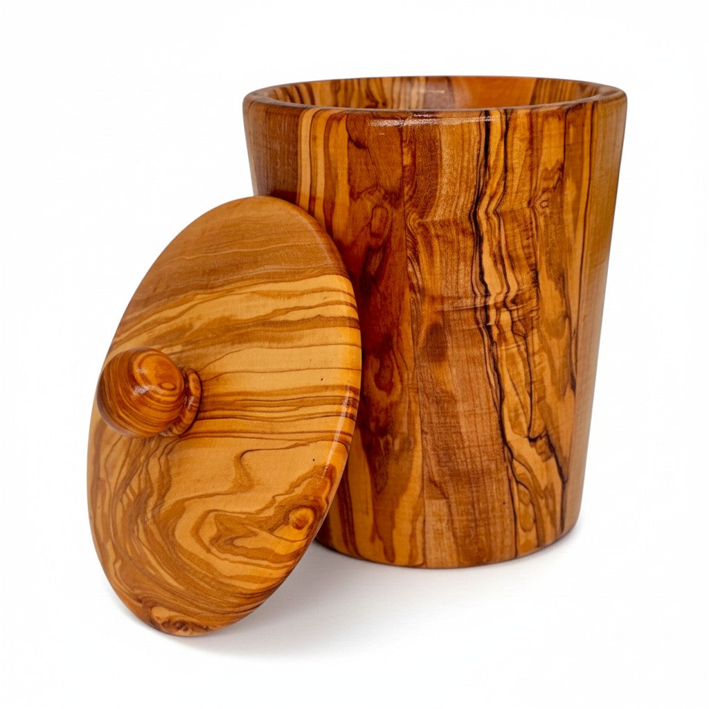 Handcrafted olive wood canister with matching lid and natural grain for storing dry ingredients in kitchen working days
