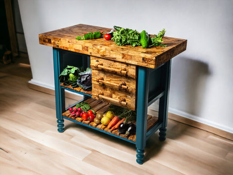 Rustic kitchen island with teal legs and drawers featuring an olive wood table butcher block top and open shelves