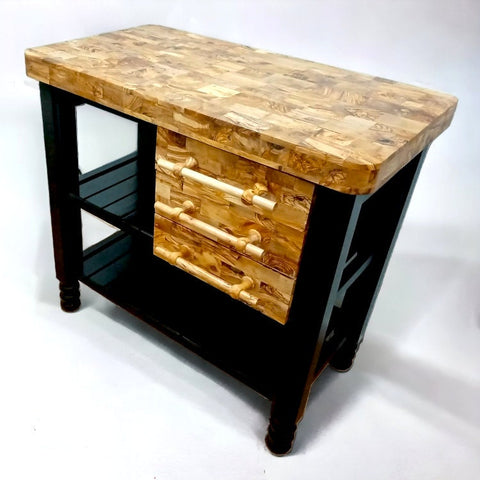 Rustic kitchen island with olive wood table butcher block top and black legs featuring three drawers with wooden handles