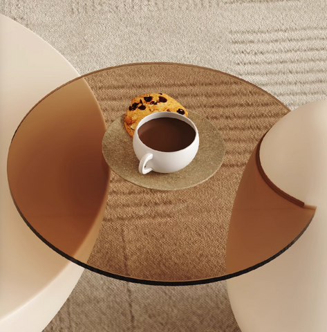 White ceramic mug of coffee on a textured gold coaster next to cookie on the oliver nesting coffee table white