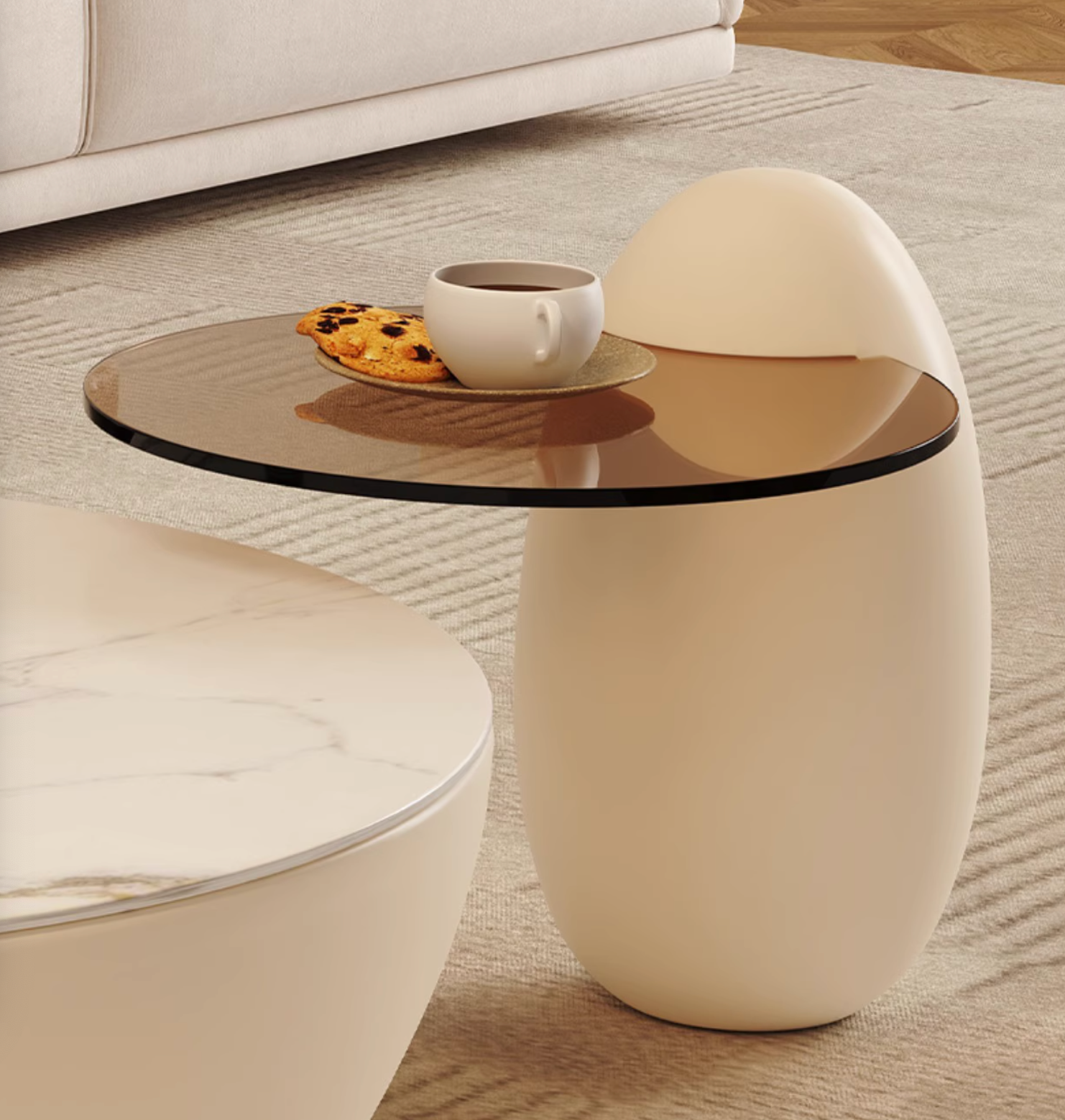 Cream-colored nesting coffee table white with egg-shaped base and round glass top perfect as a coffee table white