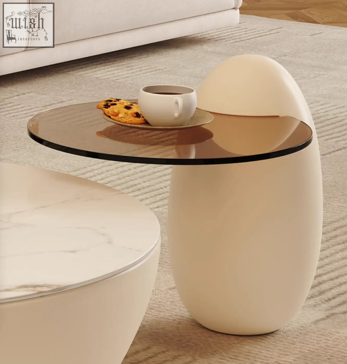 Cream-colored egg-shaped nesting coffee table with round glass top ideal as a side or nesting coffee table