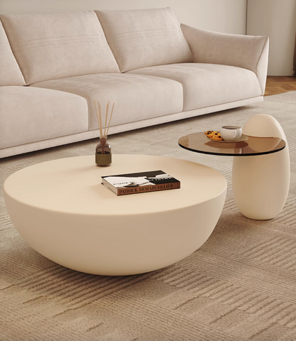 Cream-colored smooth oval white coffee table with minimalist design perfect as a nesting coffee table