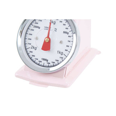 Pastel pink retro kitchen scale with silver metallic dial and red pointer for precise home baking measurements