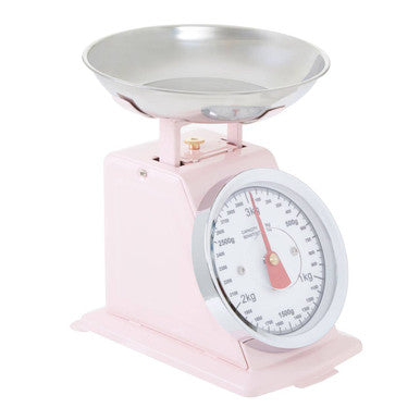 Pink retro kitchen scale with pastel pink body, silver metal bowl, and circular analog dial for precise weighing