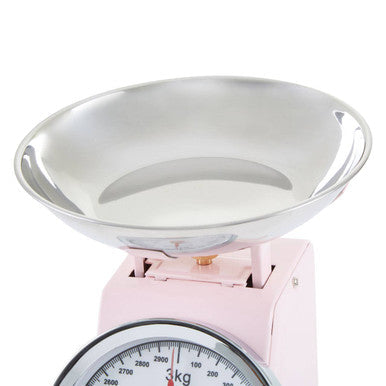 Pink retro kitchen scale with shiny silver metal bowl and circular dial marked in kilograms pastel pink retro style