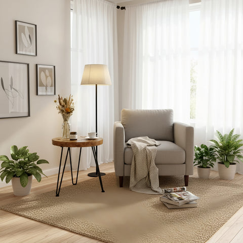 Beige upholstered armchair with textured throw blanket next to olva round chunky coffee table pictured table