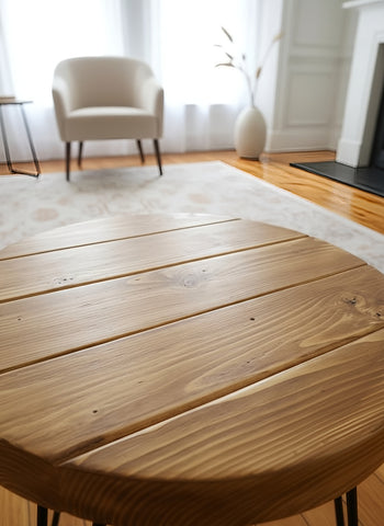 Olva round chunky coffee table with natural wood finish and black metal legs pictured table for coffee area