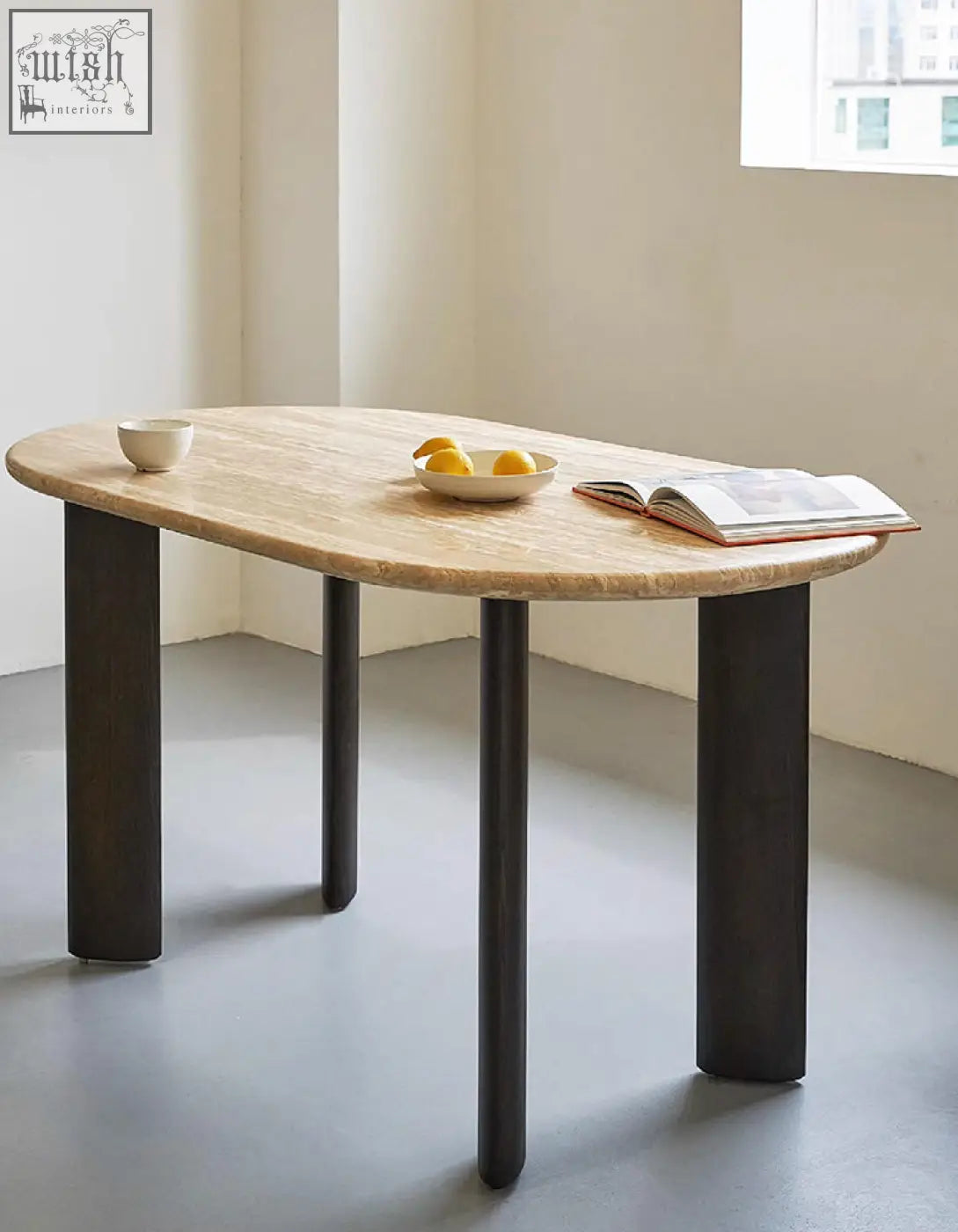 Modern oval dining table with light beige travertin marble top and sleek black solid wood legs perfect for oval dining