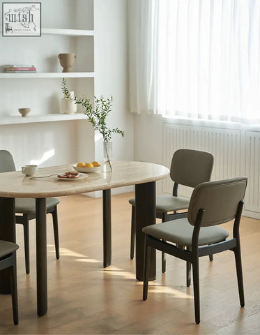 Modern oval dining table with a light beige travertin marble top and dark matte solid wood legs perfect for dining room