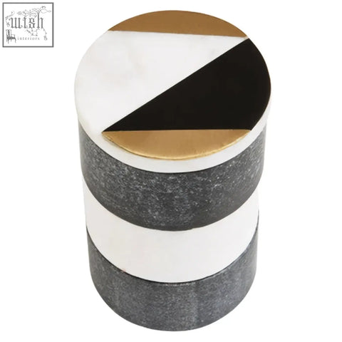 A cylindrical omari marble stacking trinket pot with a geometric black white and gold top and gray glossy bands