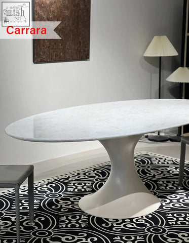 Elegant oval dining table with carrara marble top and white sculptural pedestal base for dining room use