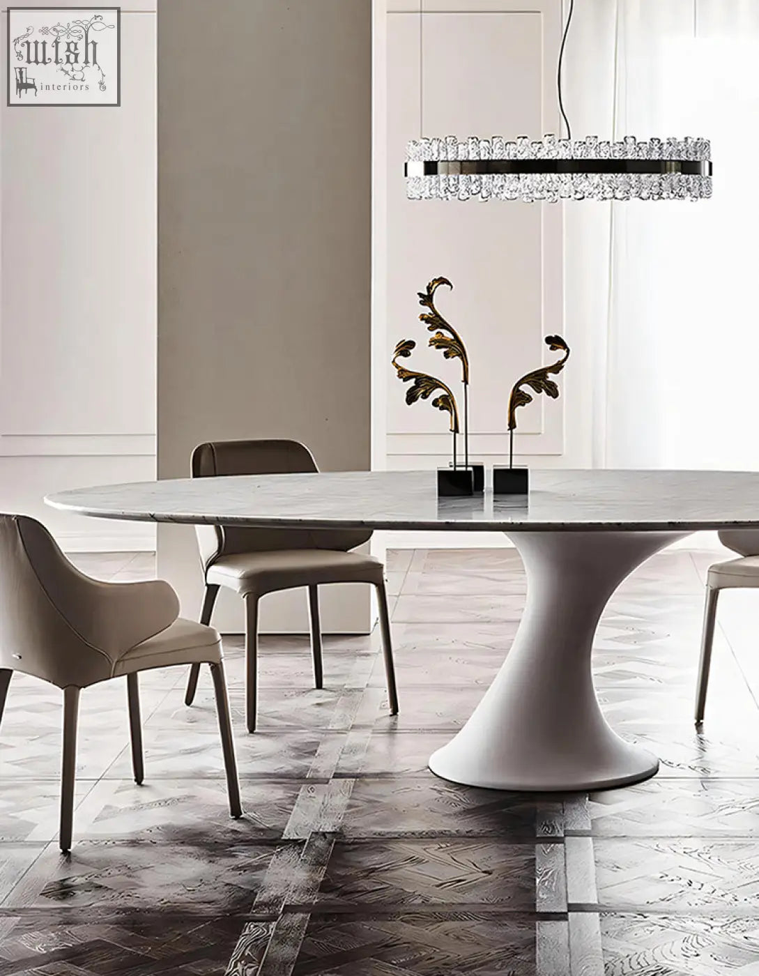 A sleek omer oval dining table with a polished white marble top and minimalist pedestal base for dining room use