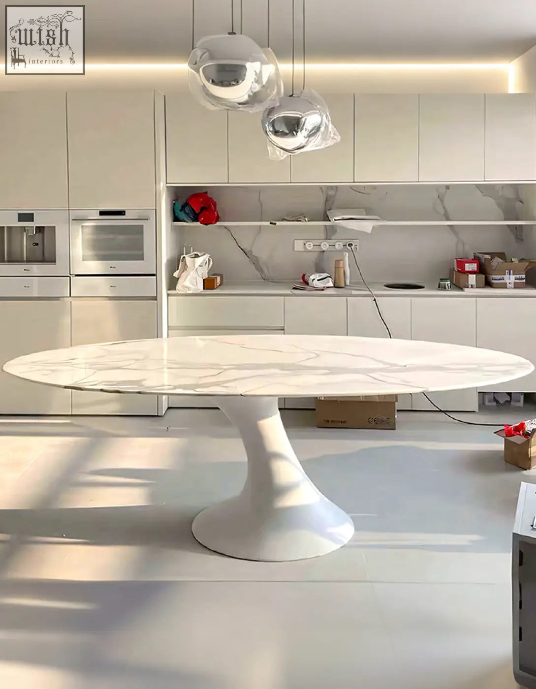 White marble oval dining table with sleek pedestal base perfect for modern dining room oval dining setups