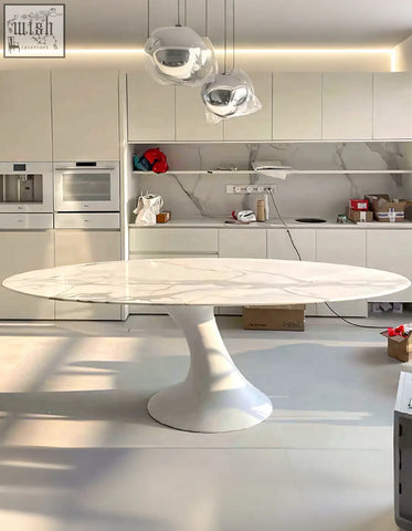 White marble oval dining table with sleek pedestal base perfect for modern dining room oval dining setups