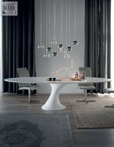 White marble oval dining table with sleek sculptural pedestal base perfect for modern dining room setups